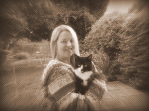 A lady, with a cat, wearing her own knitting! The horror!